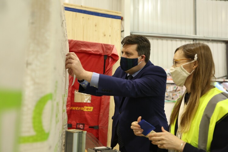 Jamie Hepburn and Sarah Lewis, research and policy director at the UK Passivhaus Trust, look at one of the new training rigs