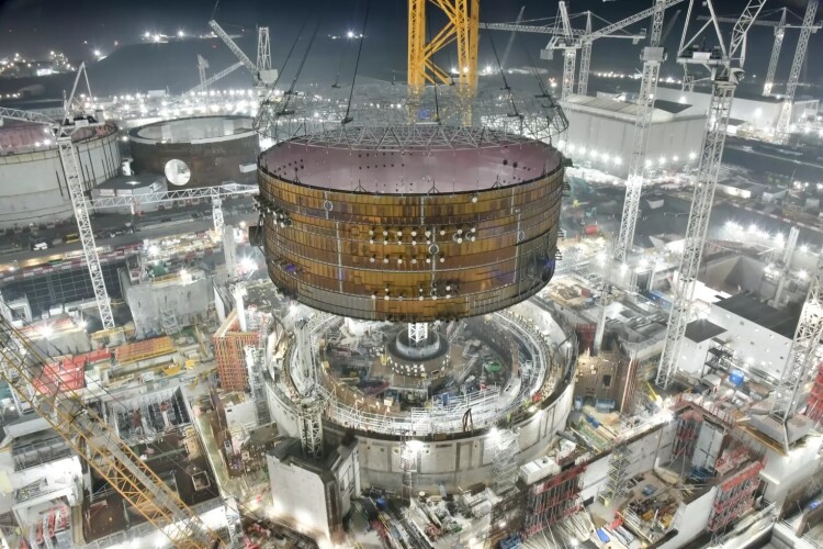 Big Carl lowers the 47-metre diameter steel ring onto the Unit 2 reactor