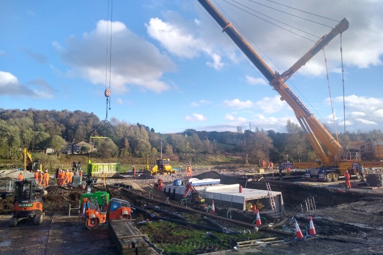 Precast concrete culvert sections are lift into place