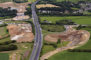 Existing layout of Junction 34 looking north. park and ride and Lune West Bridge under construction to the left of the motorway. 