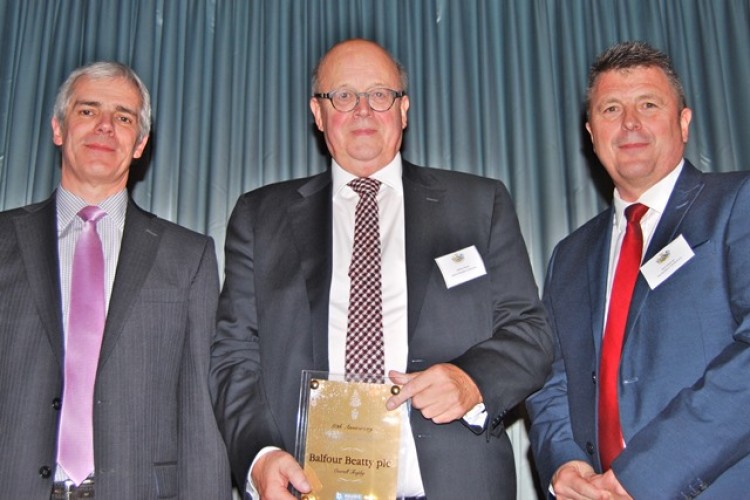 Balfour Beatty's Harry Townley (centre) collects the award from Paul Long (left) of Builder's Profile, which sponsored the event, and The Builders' Conference CEO Neil Edwards