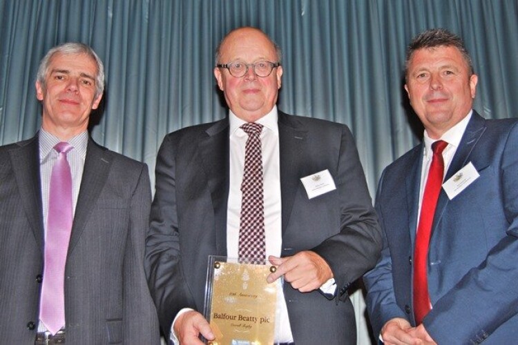Balfour Beatty's Harry Townley (centre) collects the award from Paul Long (left) of Builder's Profile, which sponsored the event, and The Builders' Conference CEO Neil Edwards