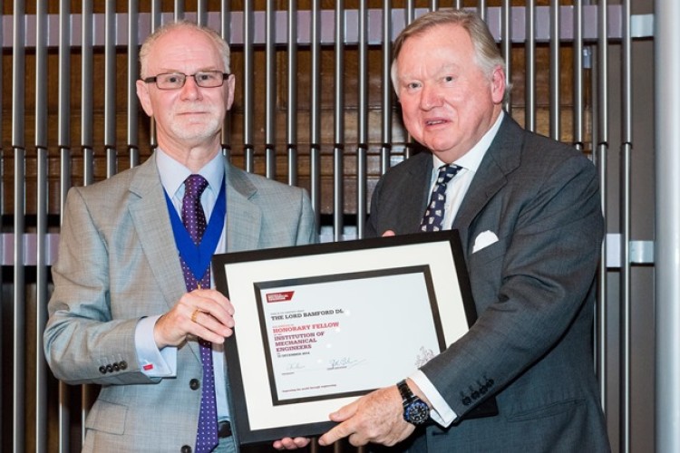 IMechE president Richard Folkson (left) hands Lord Bamford his honorary fellowship