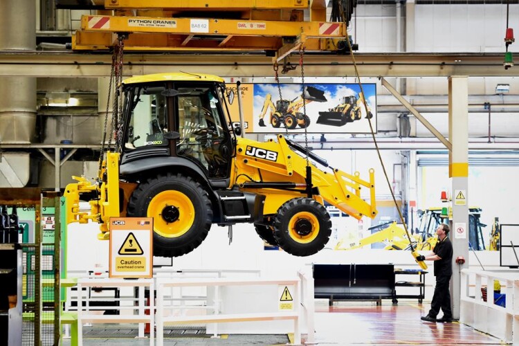 A JCB backhoe loader comes off the production line in Staffordshire